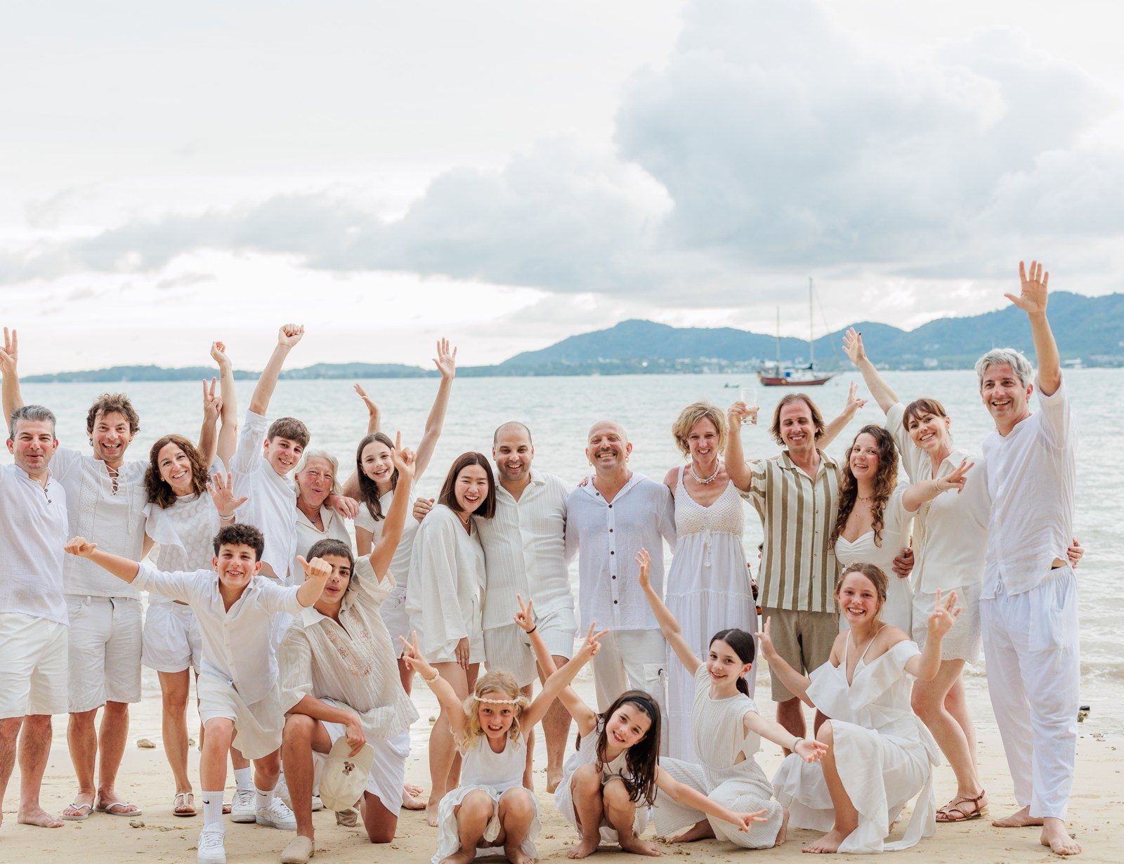Ruben's family on the beach in Thailand for the wedding, everyone in white